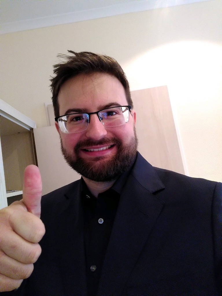 Photo showing me with thumb up in a suit.